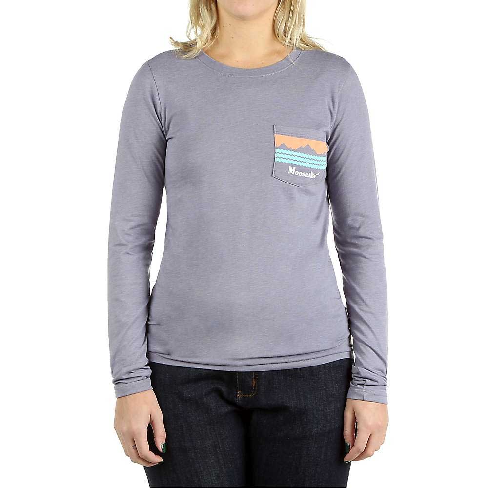 A person in the Moosejaw Womens Peak Original LS Pocket Tee—an organic cotton/recycled poly long sleeve shirt with a chest pocket, small mountain graphic, and "Moosejaw" text—paired with dark jeans against a white background.
