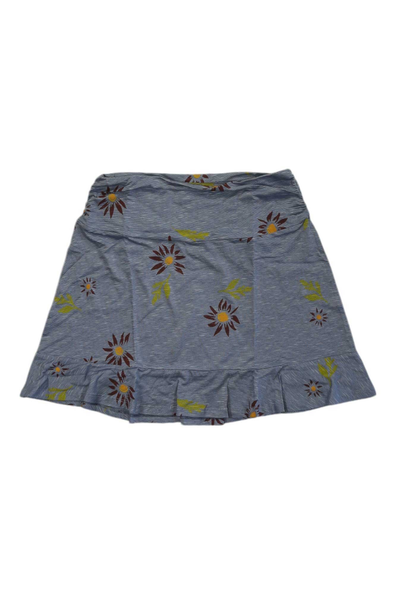 The Toad & Co Women's Chaka Ruffle Skirt is a gray A-line skirt with brown and yellow floral print and a ruffled hem, made from organic cotton. It’s shown spread flat on a white background.