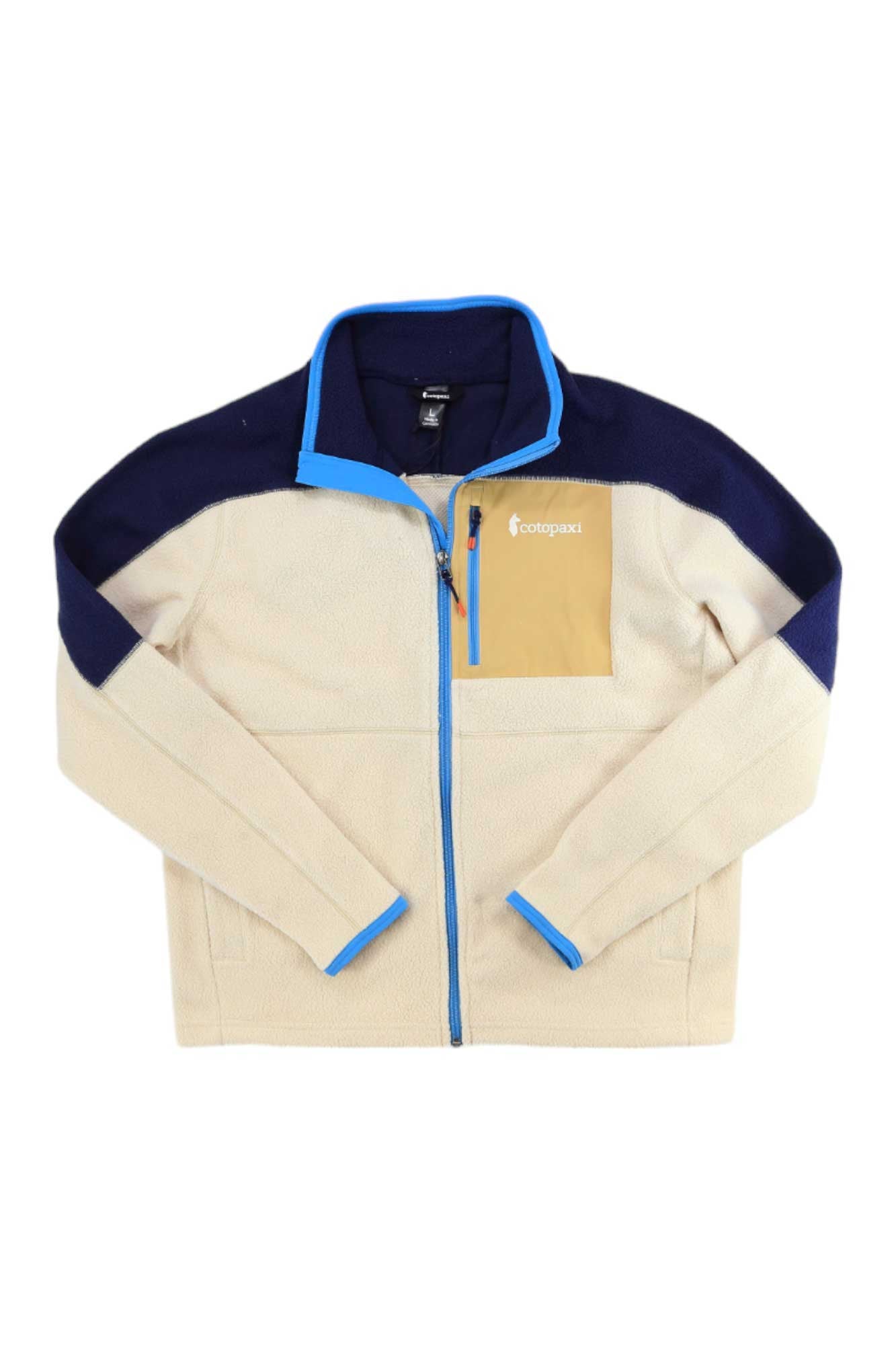 The Cotopaxi Womens Abrazo Full-Zip Fleece Jacket in cream features navy shoulders, a tan chest pocket with logo, and bright blue trim on the collar, zipper, and cuffs. Made from recycled materials for style and sustainability.
