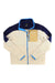 The Cotopaxi Womens Abrazo Full-Zip Fleece Jacket in cream features navy shoulders, a tan chest pocket with logo, and bright blue trim on the collar, zipper, and cuffs. Made from recycled materials for style and sustainability.