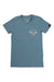 The Moosejaw Women's Monte Cristo SS Tee is a light blue vintage short sleeve crew with a small white and yellow Crochet Club logo with wings on the left chest and a black tag on the left sleeve. Made in USA.