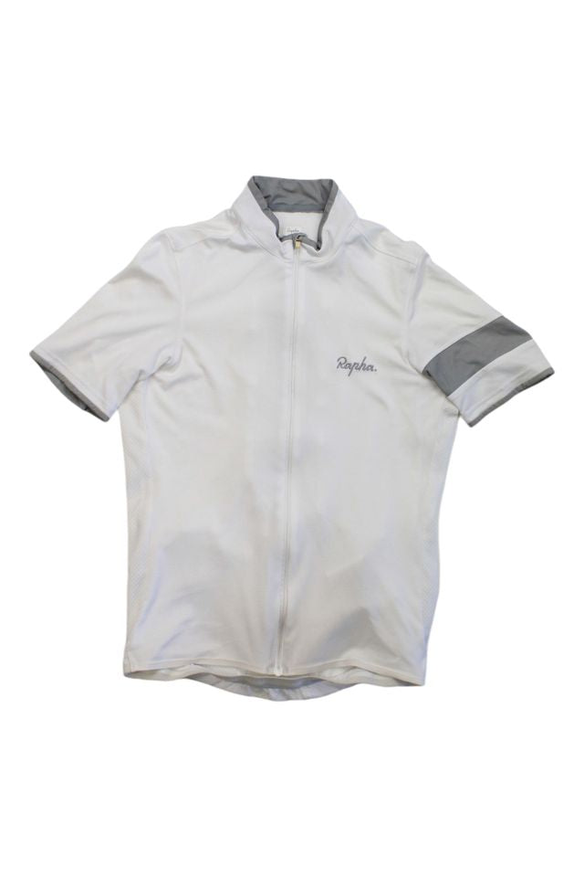 The Rapha Men's Super Lightweight Jersey is a white, short-sleeve cycling top with a full front zipper, gray collar trim, a gray armband on the left sleeve, and the Rapha logo on the left chest.