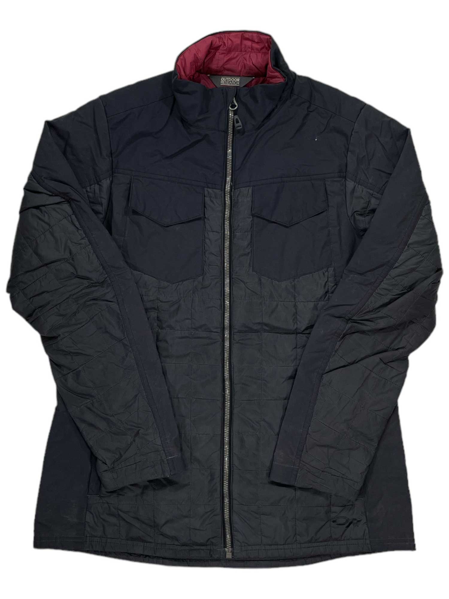 The Mens Packable Jacket is a black, insulated, quilted jacket featuring a front zipper, two chest pockets with flaps, maroon inner lining, and lightweight design. The jacket is displayed laid flat to show its front and sleeves.
