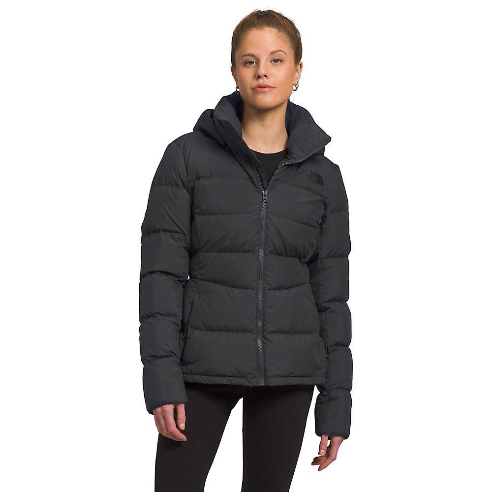 A woman in a black The North Face Womens Metropolis Jacket and black pants stands against a white background, facing the camera with a neutral expression.