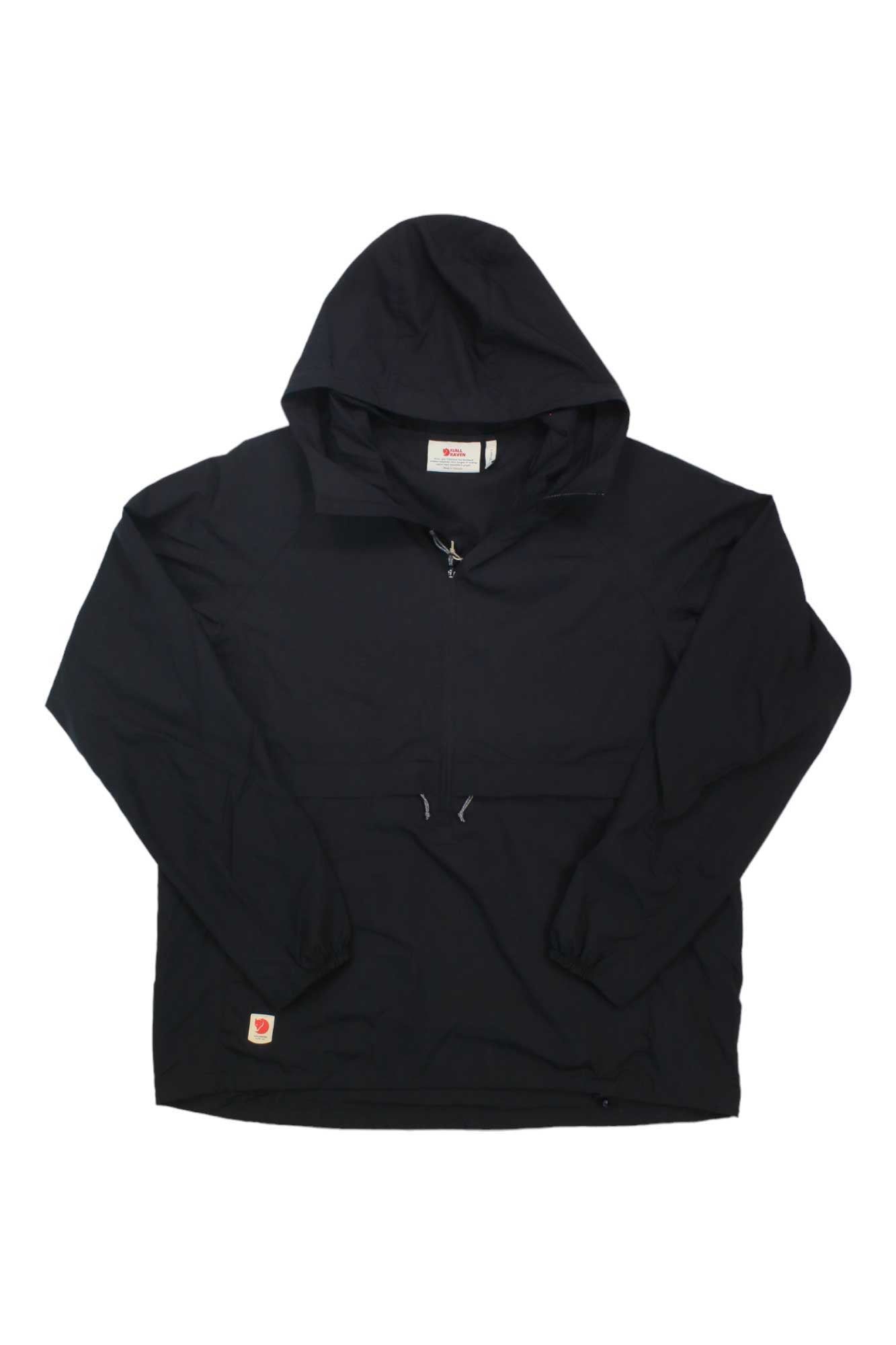 The Fjallraven Women's High Coast Lite Anorak is a lightweight, black, packable jacket with a half-zip front, elastic cuffs, and a rectangular logo patch on the lower left hem. It is displayed flat on a white background.