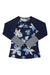 The Carve Designs Womens Kona Rashguard is a navy blue, long-sleeved rashguard with a light blue and white floral pattern, black-and-white striped cuffs, front zipper, raglan sleeves, and sun protection for comfort.