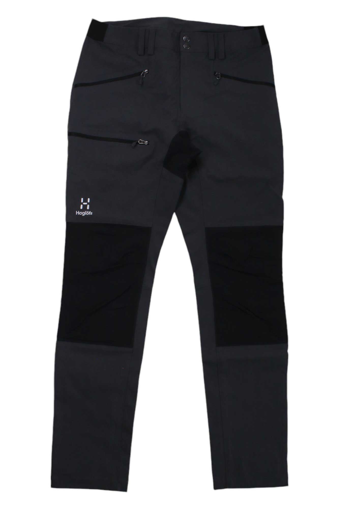 The Haglofs Mens Mid Slim Pant is a pair of black hiking pants with zippered pockets, reinforced knees, belt loops, and the Haglöfs logo. Made from water-resistant recycled material for durability and outdoor comfort.