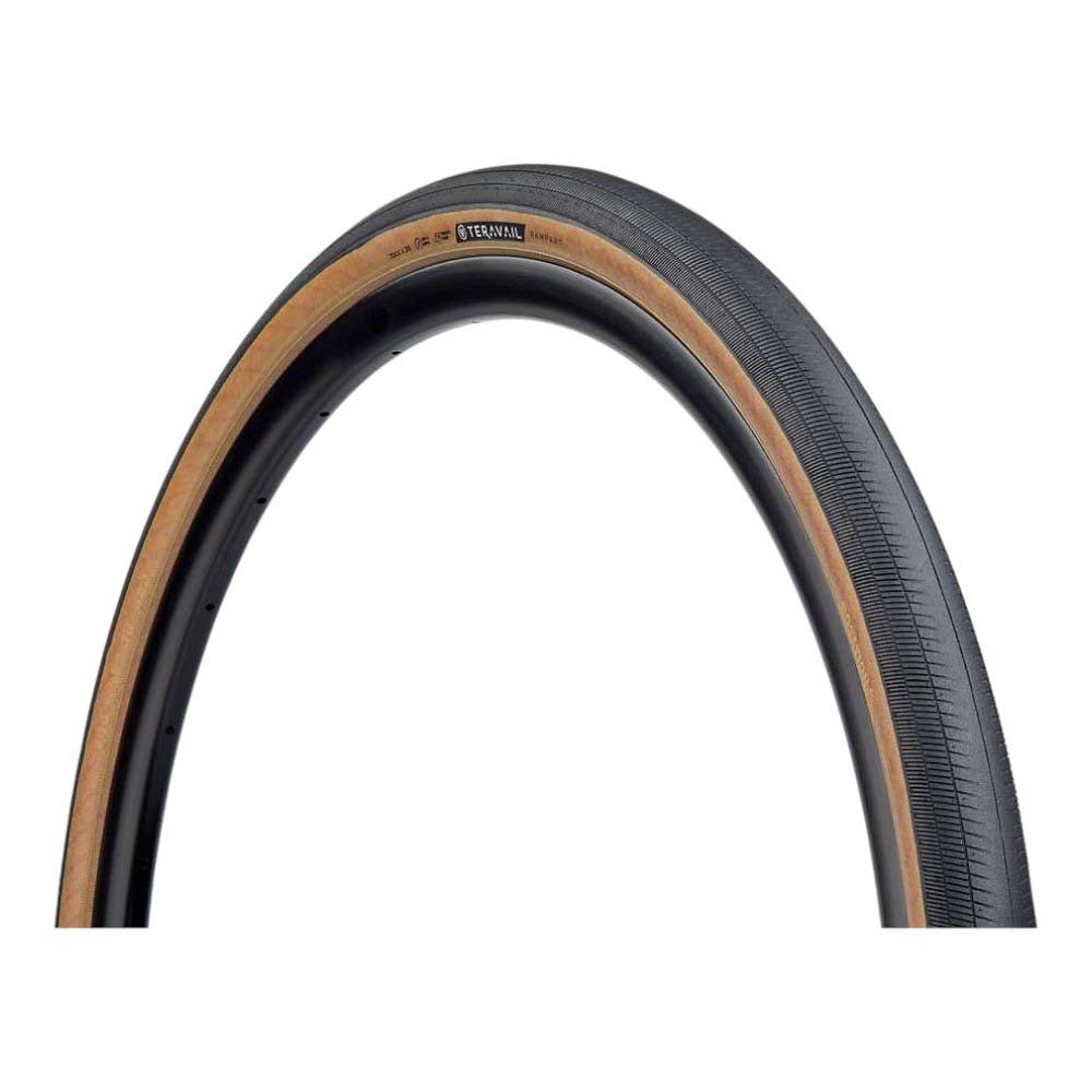 A close-up of the Teravail Rampart Tire - 700, a high-performance bike tire with a tan sidewall and smooth black tread, shown isolated on a white background.