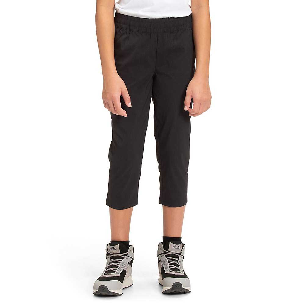Black capri pants with tapered legs and elastic waist, worn mid-calf