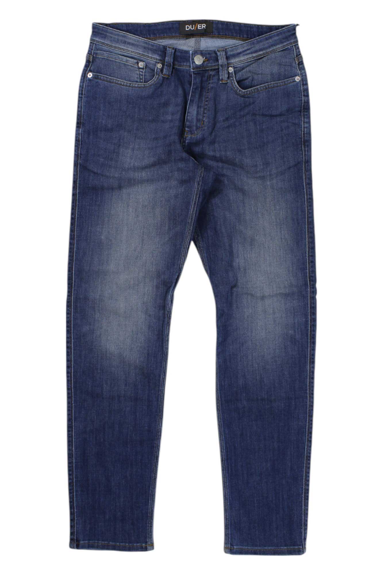 The DU/ER Mens Performance Denim Jean - Slim Fit features dark blue denim, a classic five-pocket design, slightly tapered legs, and subtle fading on the thighs and knees, displayed flat on a white background.