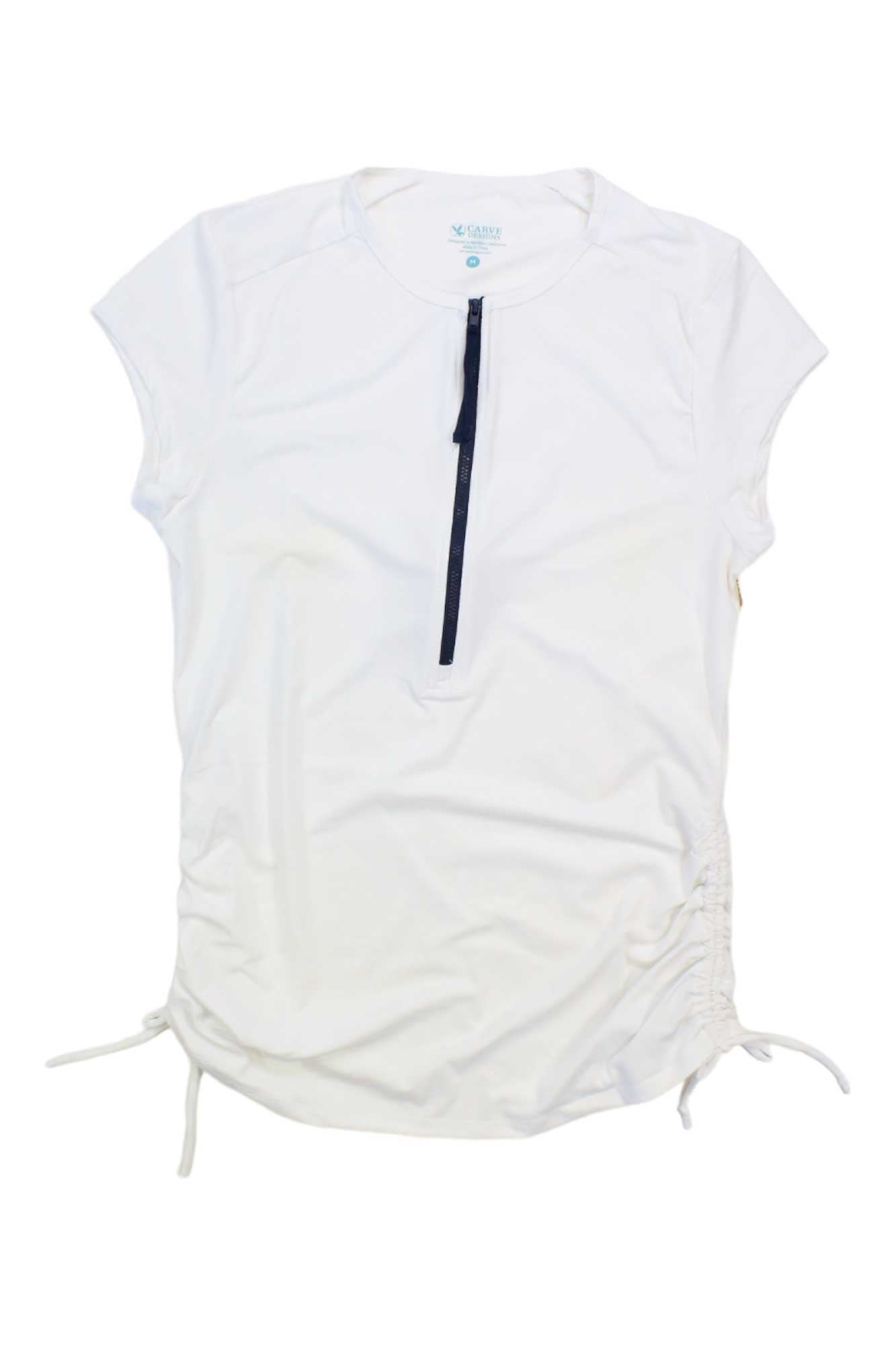 The Carve Designs Women's Dawson Rashguard is a white, short-sleeve swim shirt with UPF 50+, round neckline, partial front zipper, and side ruching with adjustable drawstrings, shown on a plain white background.