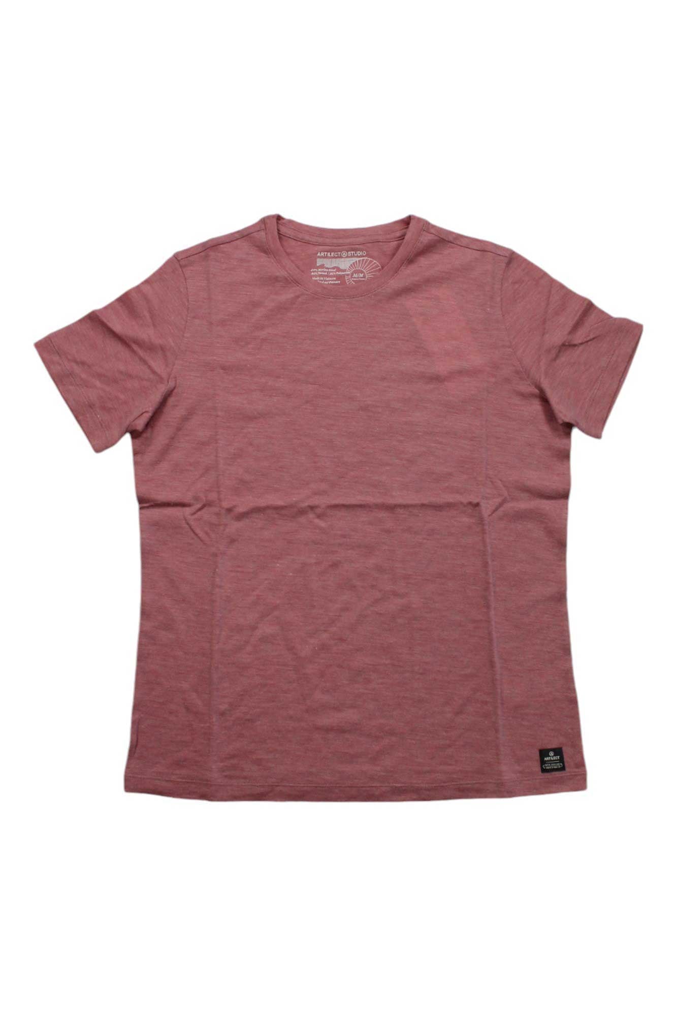 The Artilect Women's Utilitee T-Shirt is a plain, short-sleeved, crew neck merino wool top in muted red, shown flat on white. It's odor resistant, quick drying, and has a small black label near the left bottom hem.