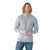 A smiling man with shoulder-length curly hair wears a light gray Smartwool Mens Texture Half Zip Sweater and blue jeans, standing with his hands clasped in front of a plain white background.