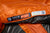 Close-up of the Nemo Mens Disco 30 Sleeping Bag (orange/gray, 3-season), showing its label with temperature ratings, brand logo, QR code, and recycling info; model: DISCO 30° MENS REGULAR—designed for side-sleepers.