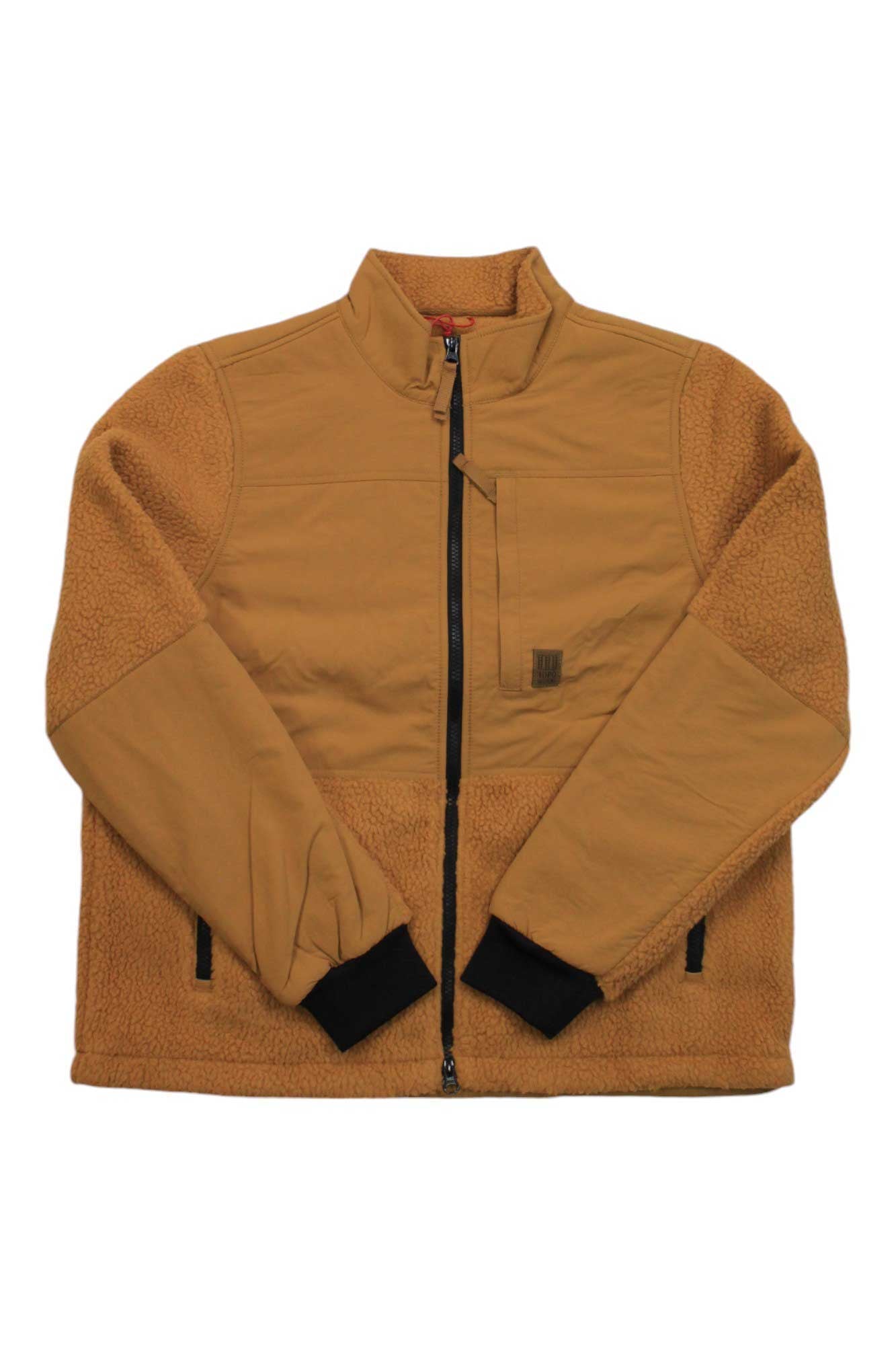 The Topo Designs Womens Subalpine Fleece Jacket is a tan fleece with black cuffs, a high collar, chest pocket, and mixed smooth and textured recycled sherpa panels for added style and warmth.