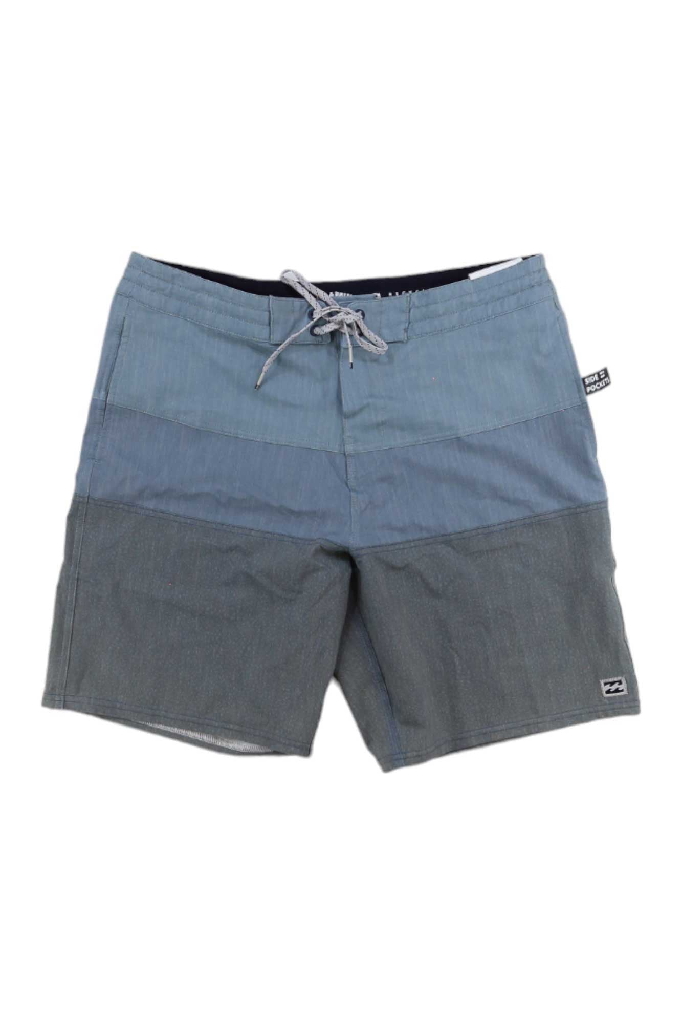 The Billabong Mens Tribong LT Boardshort features a two-tone blue design, 4-way stretch fabric, drawstring waist, small front left leg logo patch, and a side label on the waistband.
