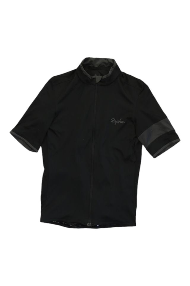 The Rapha Men’s Super Lightweight Jersey is a short-sleeve black cycling top with a front zipper, high collar, subtle Rapha branding on the chest, and darker bands on the sleeve ends.