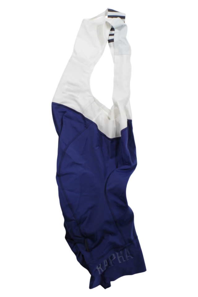 A pair of Rapha Mens Pro Team Bib Shorts II - Long with white straps and a blue lower section, shown flat on a white background. They feature a dual-density chamois pad and subtle RAPHA branding on one leg.