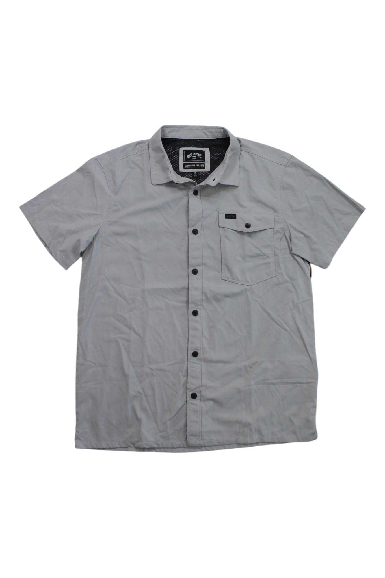 A Billabong Mens Surftrek Tech SS Shirt in light gray, crafted from recycled nylon with short sleeves, a collar, and a single chest pocket, is displayed flat on a white background.