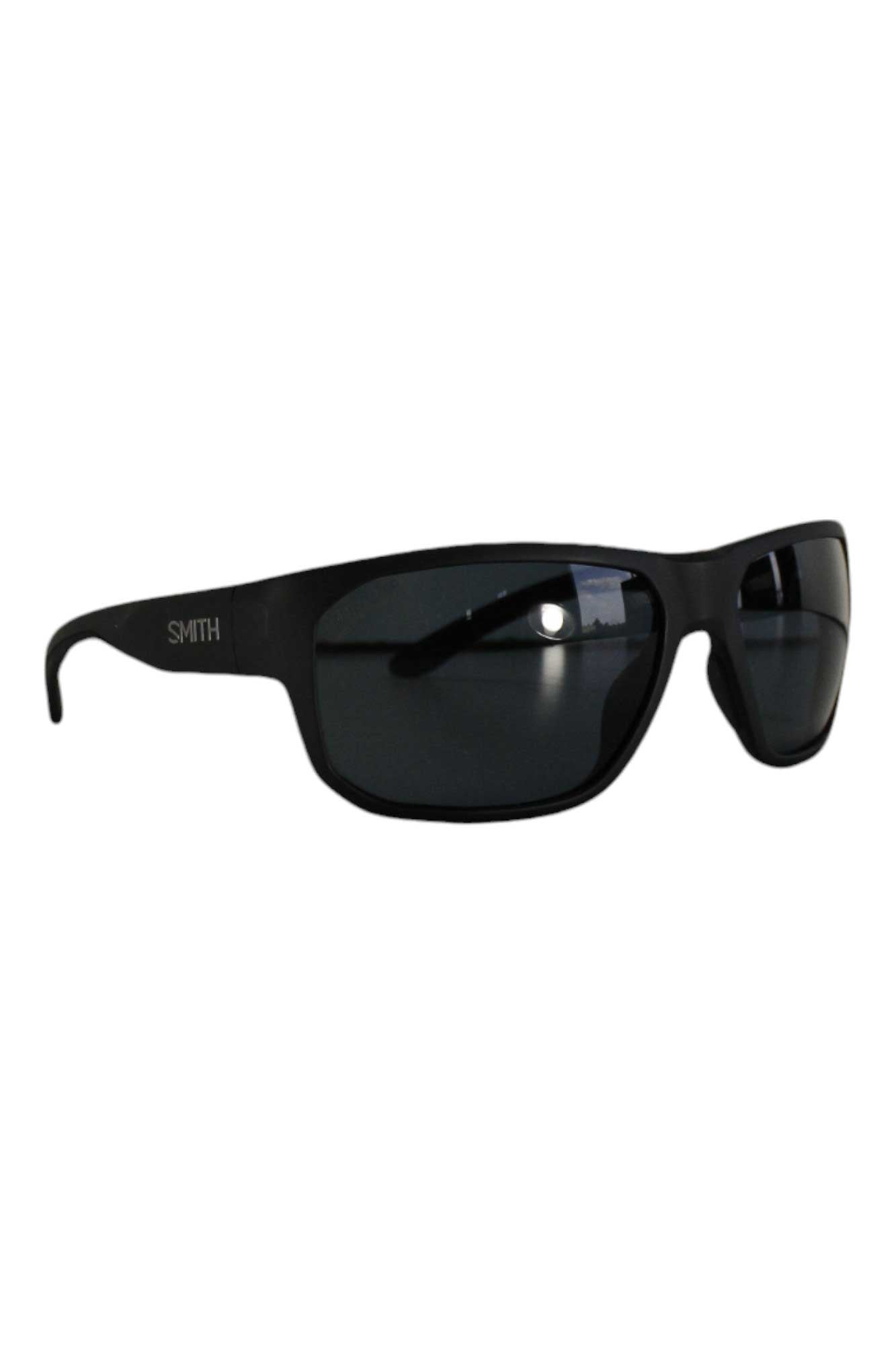 The Smith Arvo Polarized Sunglasses feature a black frame, rectangular dark lenses, SMITH in white on the left temple, and a comfortable wraparound fit for added coverage.