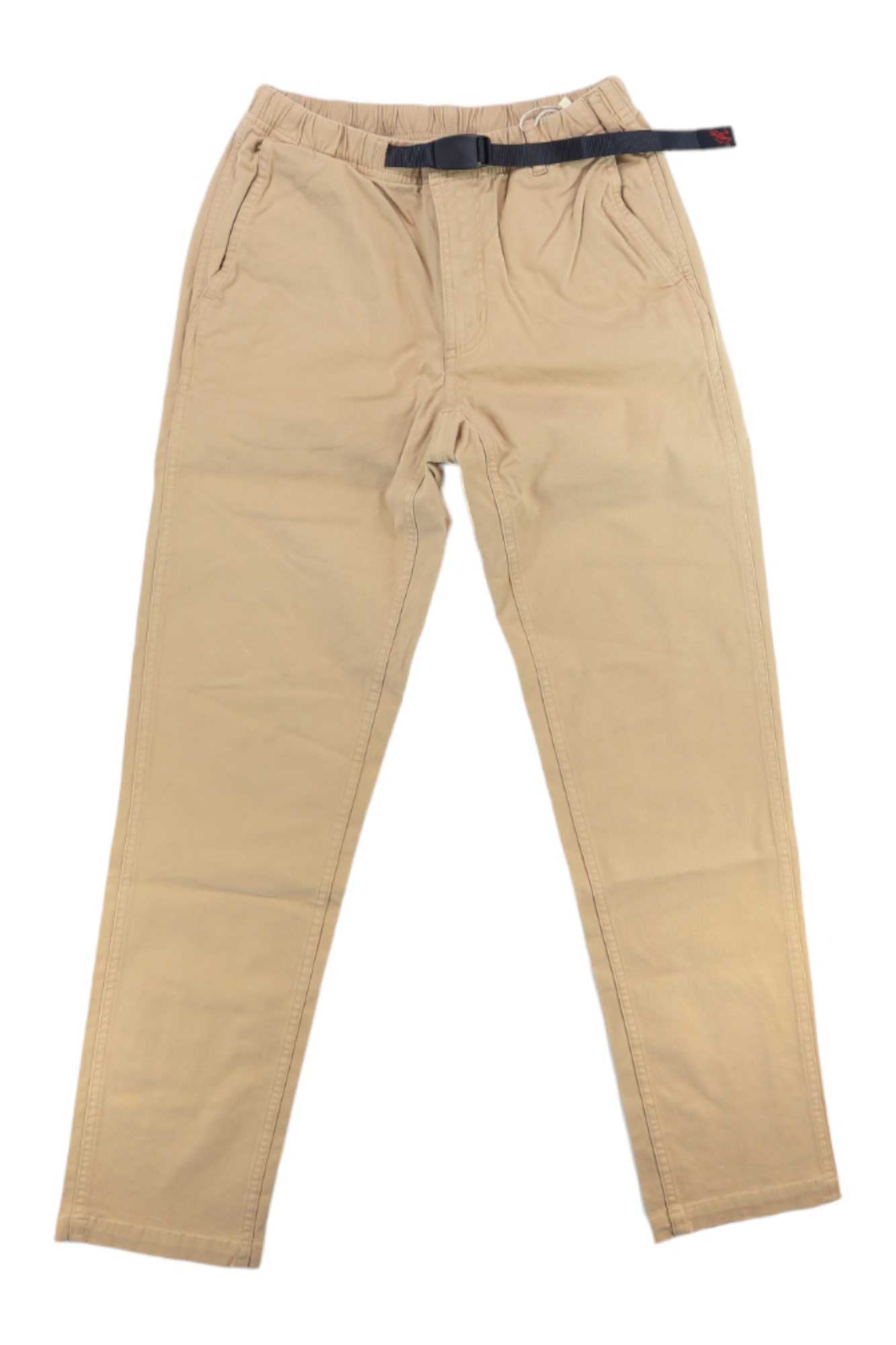 The Gramicci Womens Tapered Pant in beige cotton stretch twill features an elastic waistband, side pockets, and an integrated black belt with a red accent, shown laid flat on a white background.