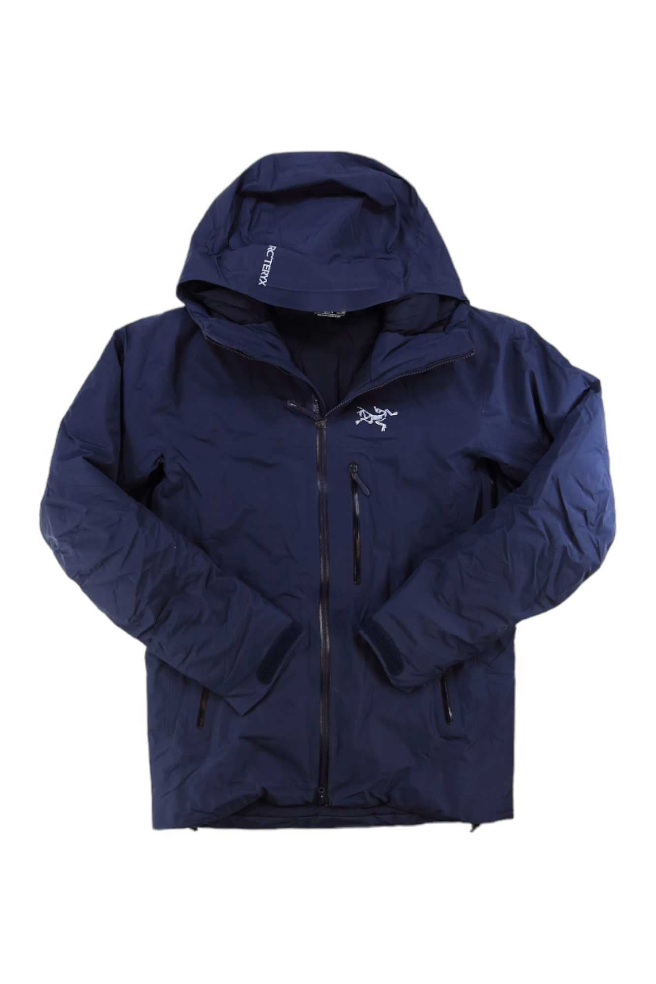 The Arcteryx Mens Beta Insulated Jacket is a navy blue GORE-TEX men's jacket featuring a front zipper, zippered chest pocket, and the Arcteryx logo on the left chest. It’s shown laid flat with sleeves angled slightly inward.