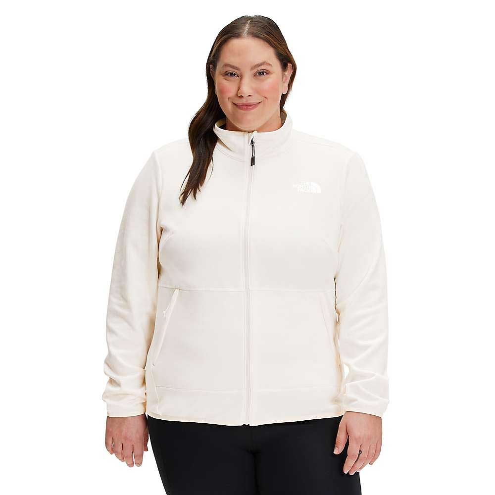 A woman with long dark hair wears The North Face Womens Plus Canyonlands Full Zip Jacket, paired with black pants, standing and smiling against a white background.