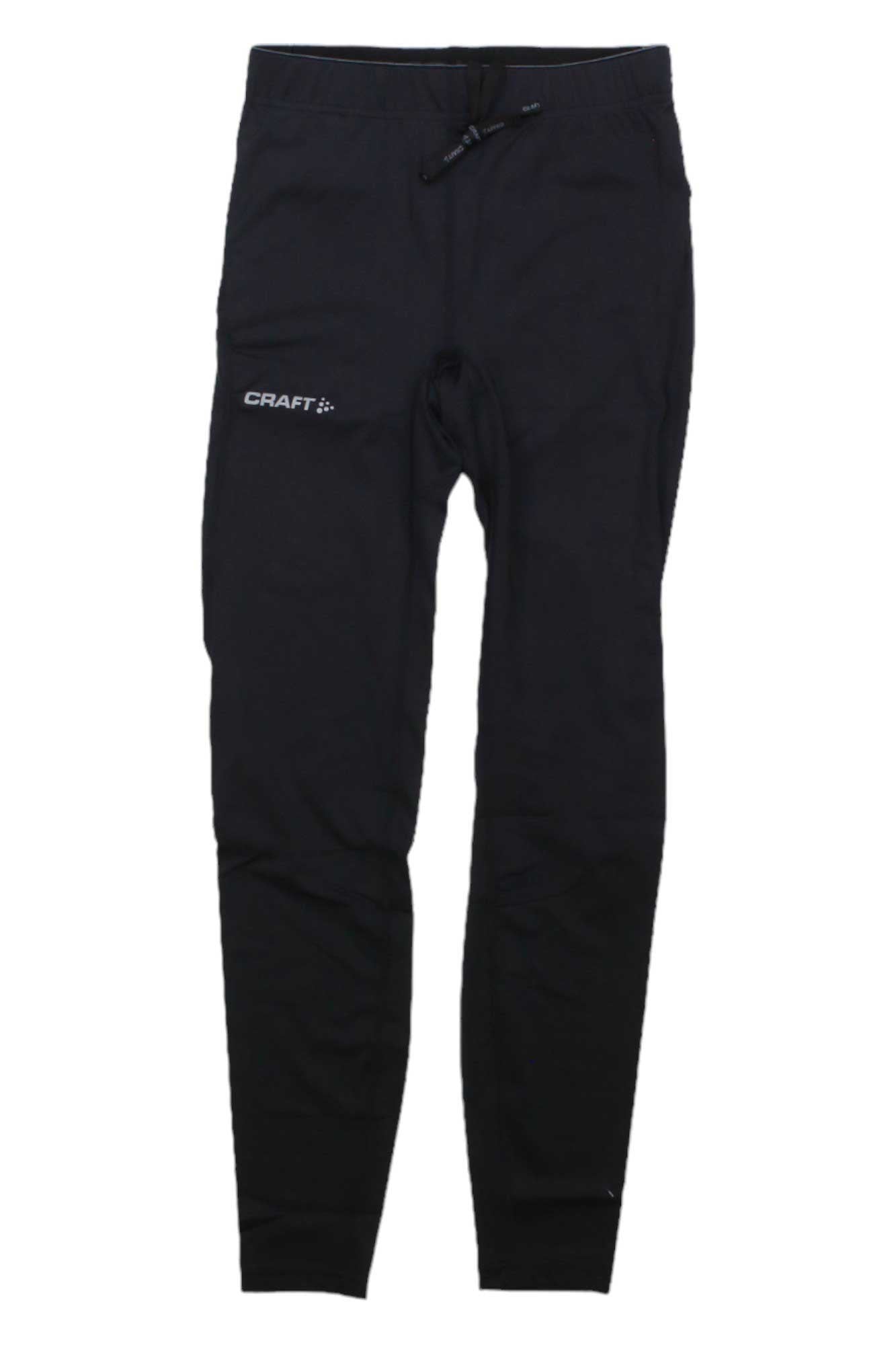 The Craft Sportswear Men's ADV Essence Compression Tight are black jogger pants with an elastic waistband, drawstring, and "CRAFT" printed in white on the upper left thigh. They feature moisture-wicking fabric and a slight compression fit for support.