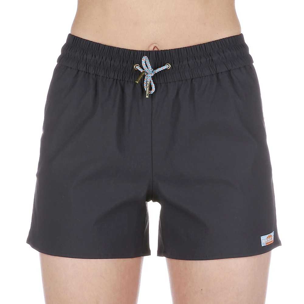 A person wears Moosejaw Womens THE Moosejaw Short in black, featuring water-resistant fabric, an elastic waistband with drawstring, and a small logo patch near the left hem. The background is plain white.