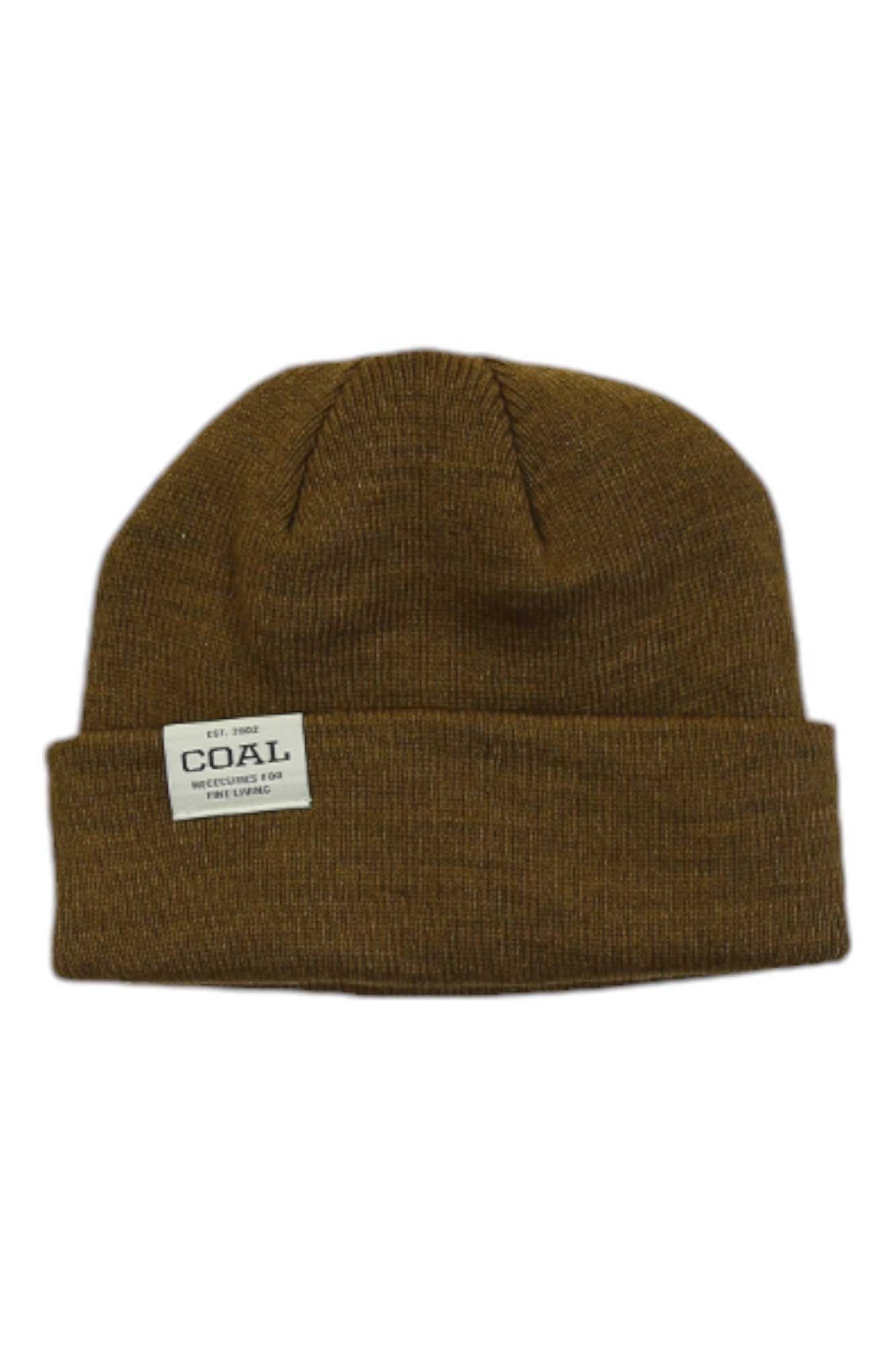 The Coal The Uniform Low Beanie is a brown ribbed knit beanie with a folded brim and a white rectangular patch label reading "COAL" on the front, making it a stylish unisex winter accessory shown against a white background.