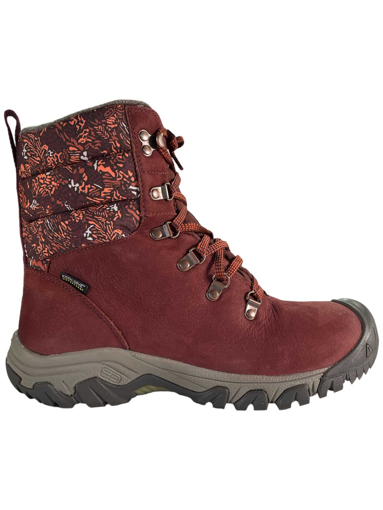 The KEEN Womens Greta Waterproof Boot features a maroon color, rugged sole, orange and brown patterned ankle, metal eyelets, matching laces, and thermal insulation—perfect for outdoor activities.