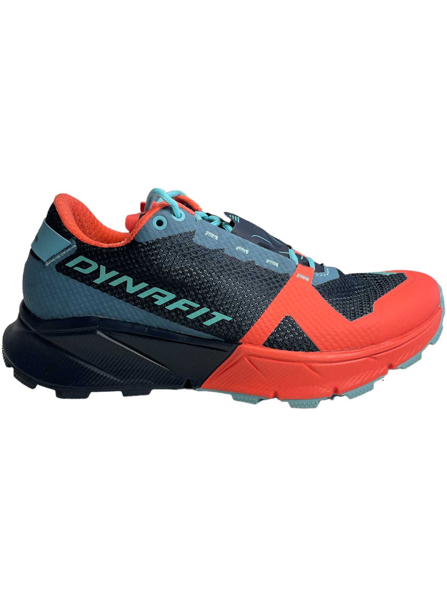 The Dynafit Womens Ultra 100 Shoe features a black mesh upper, red accents on the toe and heel, turquoise laces, a turquoise Dynafit logo, and a Vibram outsole with black/red rugged tread for superior grip.