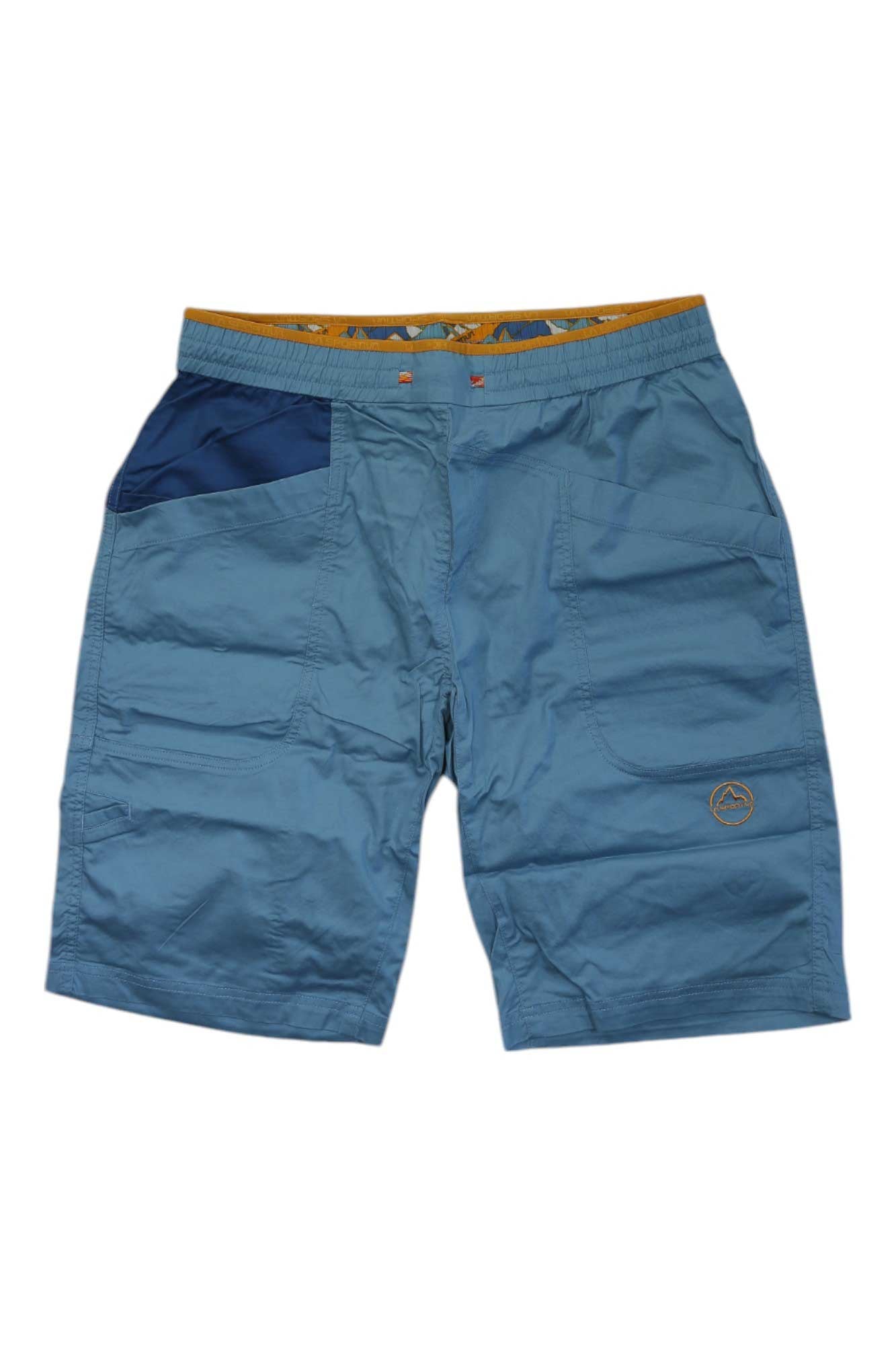 The La Sportiva Mens Bleauser 12 Inch Short features blue, knee-length design, elastic waistband, dark blue right pocket, subtle stitching, small logo near the left hem, and yellow-patterned organic cotton lining.