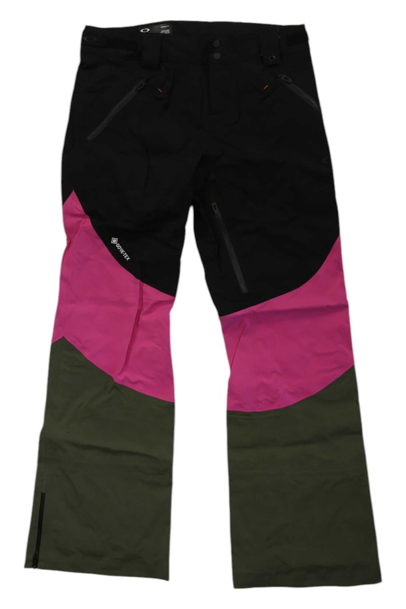 The Oakley Women's Spellbound 2.0 Shell 3L GTX Pants feature a black upper, diagonal pink midsection, olive green bottom, zippered pockets, and a relaxed fit—ideal snowboard pants for women.