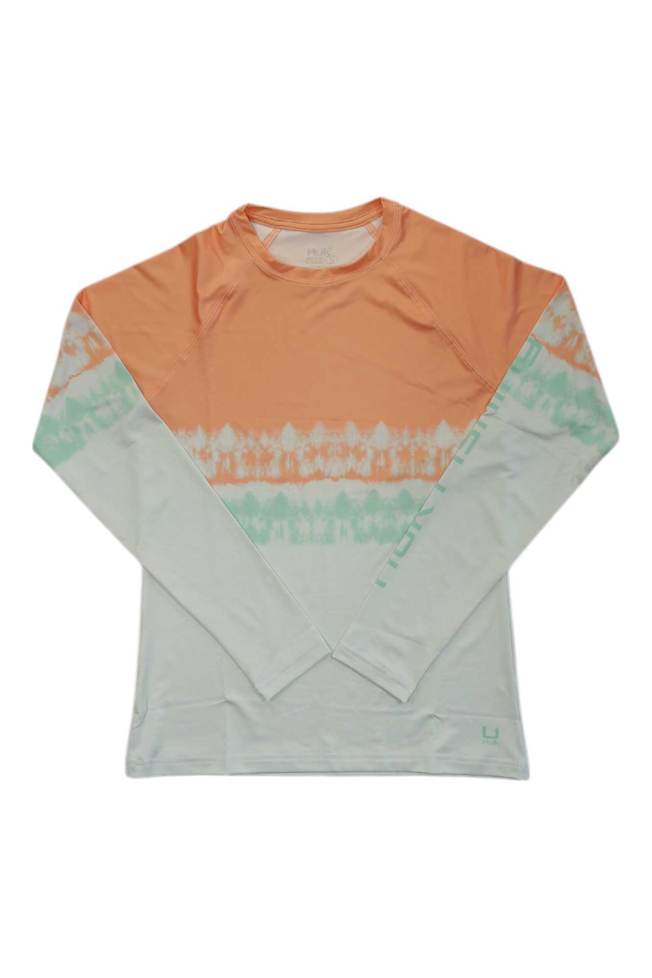 The Huk Womens Salt Dye Stripe Pursuit shirt features UPF 30+ sun protection, an orange upper, mint green tie-dye stripes, and a light gray lower section. It’s a moisture-wicking long sleeve laid flat on a white background.
