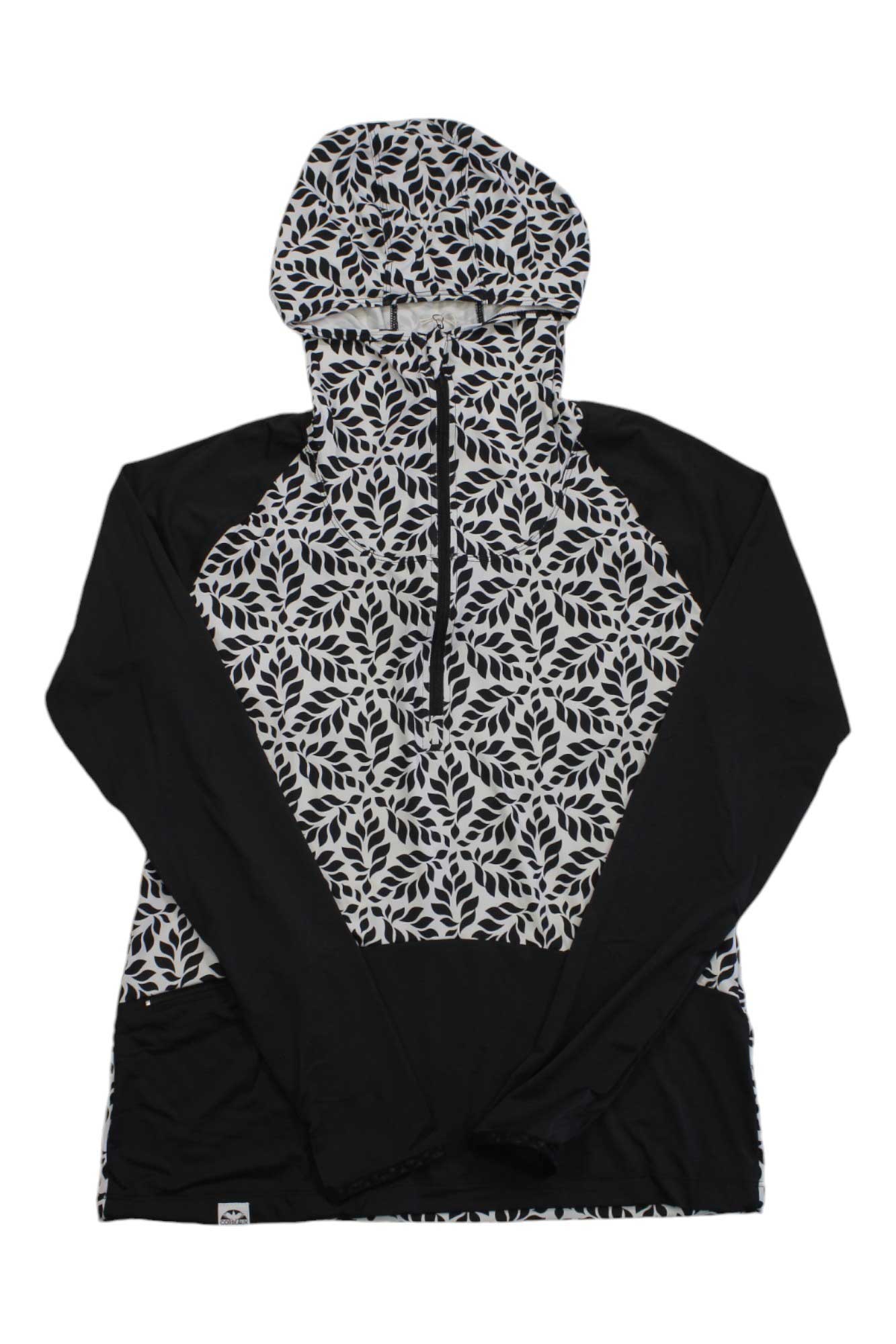 The Corbeaux Womens Seeker Hoody features a black and white leaf pattern on the hood, chest, and sleeves with solid black sides. This bluesign certified pullover offers UPF 50+ sun protection and includes a half-zip front.