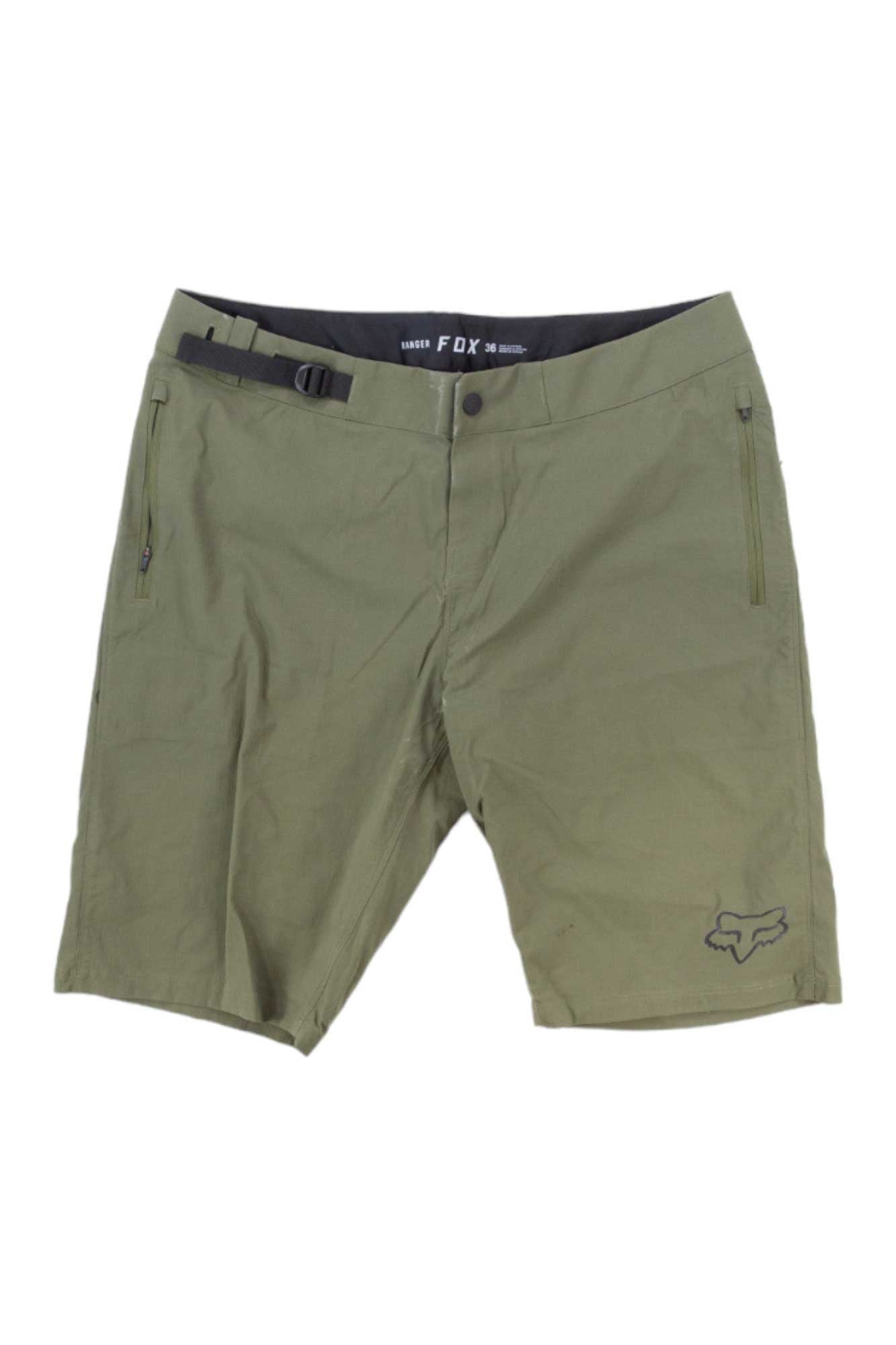 The Fox Mens Ranger Short in olive green features zippered side pockets, a built-in adjustable belt, a small Fox logo on the left leg, and a black inner waistband with FOX branding—ideal for mountain biking adventures.