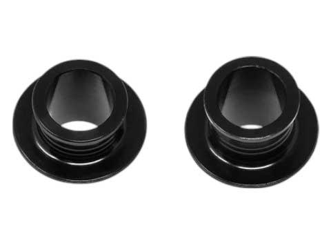 Two black Wheels Manufacturing Outer Axle Nuts made from high-grade steel with central hexagonal holes are shown side by side on a white background. Perfect for use as outer axle nuts in solid-axle bikes.