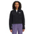 A woman with curly hair faces the camera wearing The North Face Women's TNF Polartec 100 1/4 Zip Jacket in black with long sleeves and loose purple pants. The jacket is made from recycled fleece.