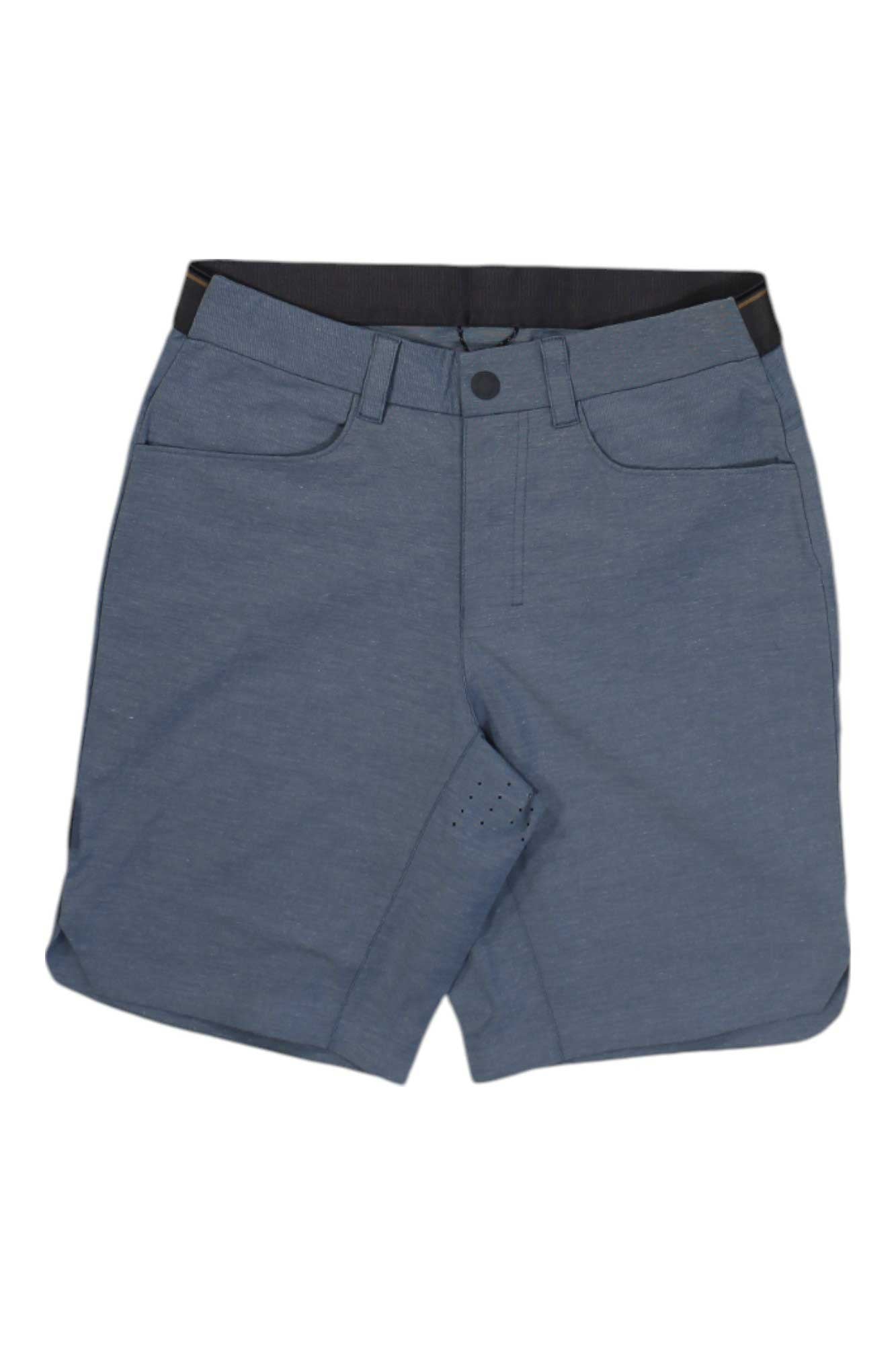 The Club Ride Mens Rider Printed Short is knee-length, blue-gray, with front pockets, belt loops, and a button closure. These stretch shorts are shown flat on a white background.