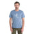 A man with short brown hair and a trimmed beard wears the Icebreaker Mens Tech Lite II SS Tee - Skiing Yeti in light blue and green pants, standing against a plain white background.