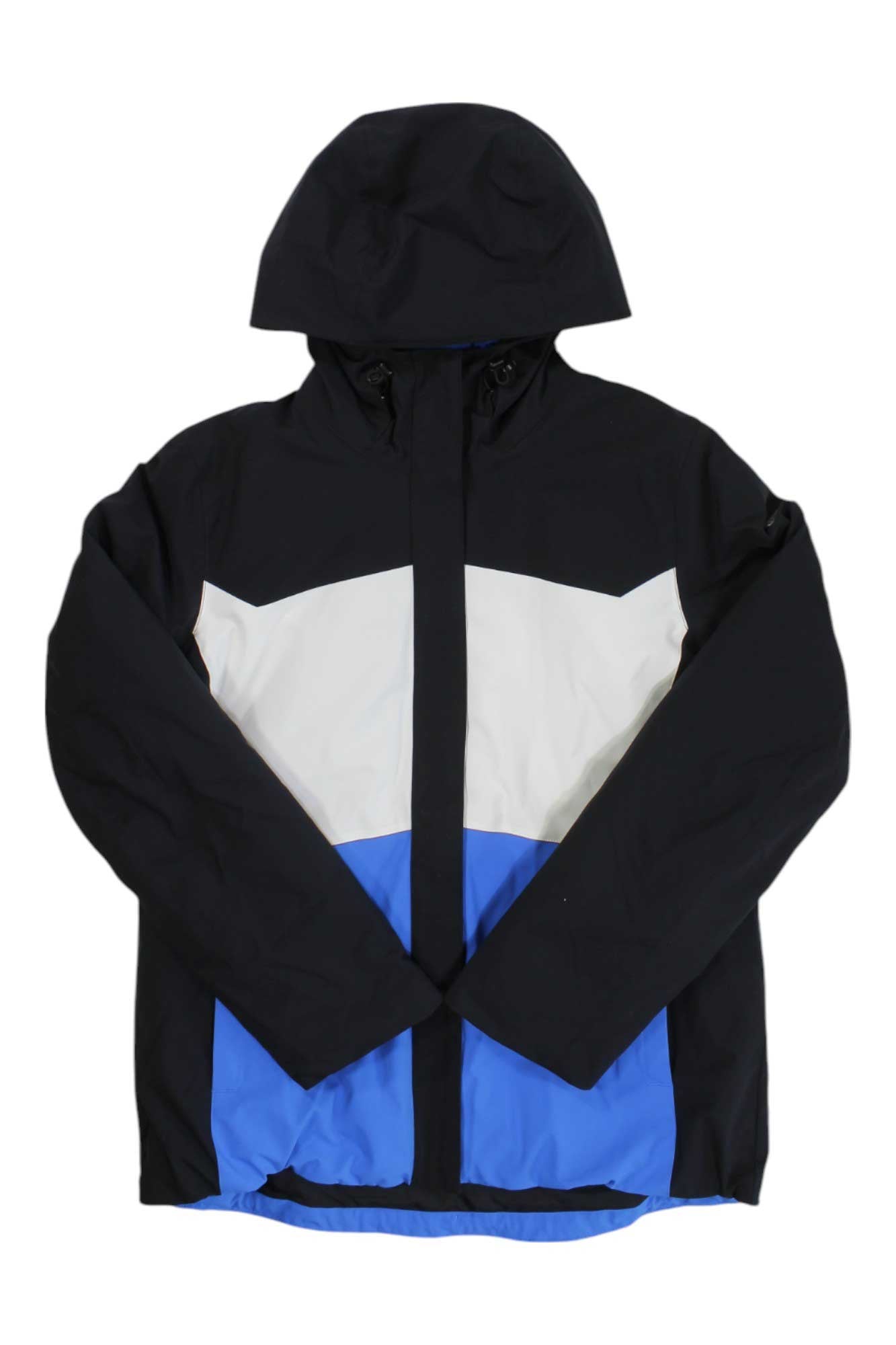 The Spyder Womens Paradise Jacket is a color-blocked, hooded ski jacket with long sleeves—black on top and sleeves, white midsection, and blue lower section—shown against a white background.