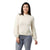A woman with long dark hair smiles against a white background, wearing the Smartwool Women's Cozy Lodge Bell Sleeve Sweater in cream paired with gray jeans.