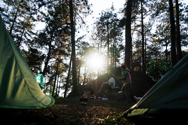 family sitting by their campsite