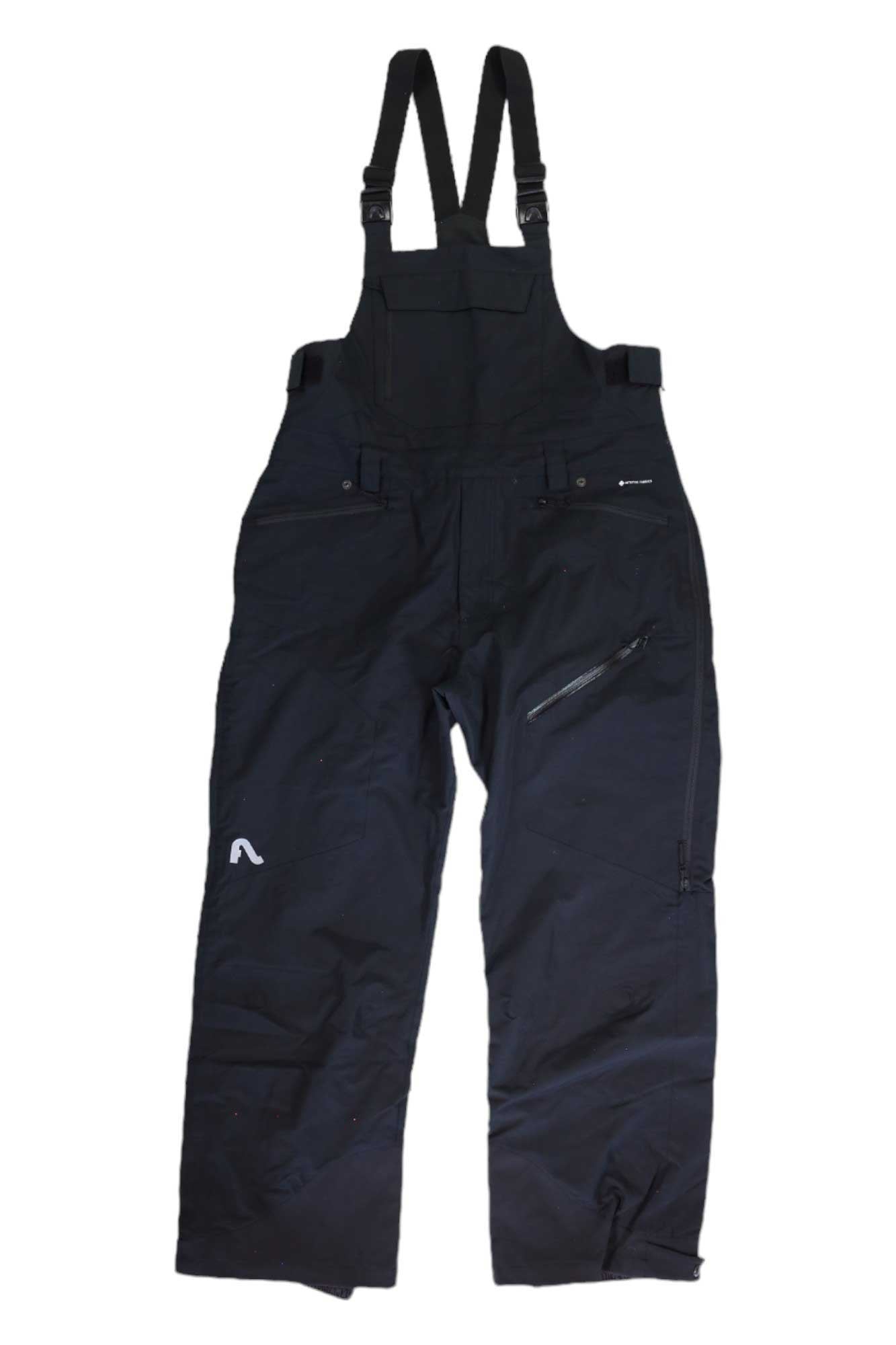 Flylow Men's Snowman Bib in black, waterproof and insulated, features adjustable shoulder straps, a front chest pocket, side zipper pocket, and a small white logo on the left leg. Shown laid flat on a white background.