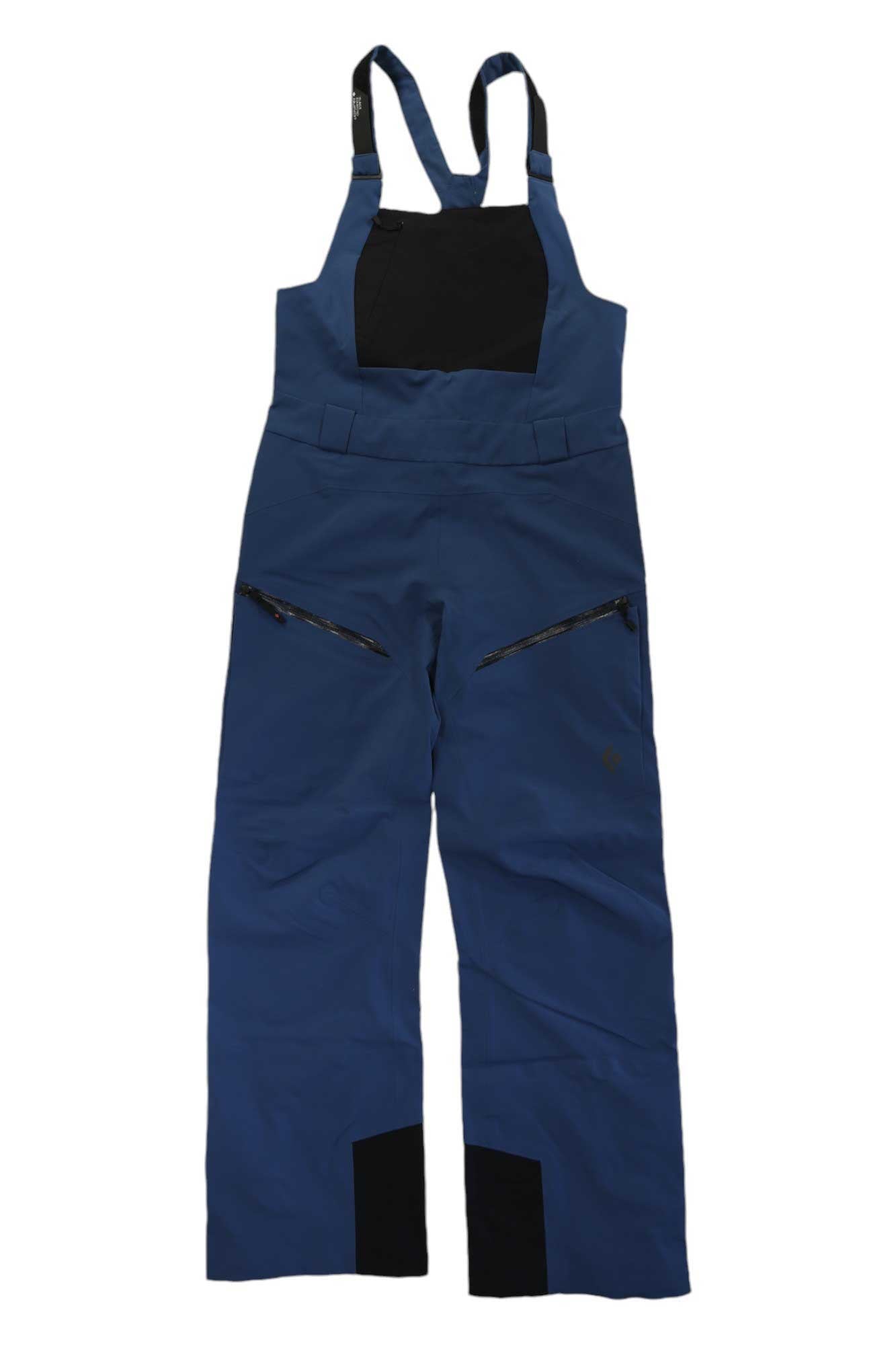 Blue Black Diamond Women's Recon Stretch Bib with black chest panel, two diagonal zippered thigh pockets, and reinforced black inner lower legs, shown flat on white background; similar style to previous model.