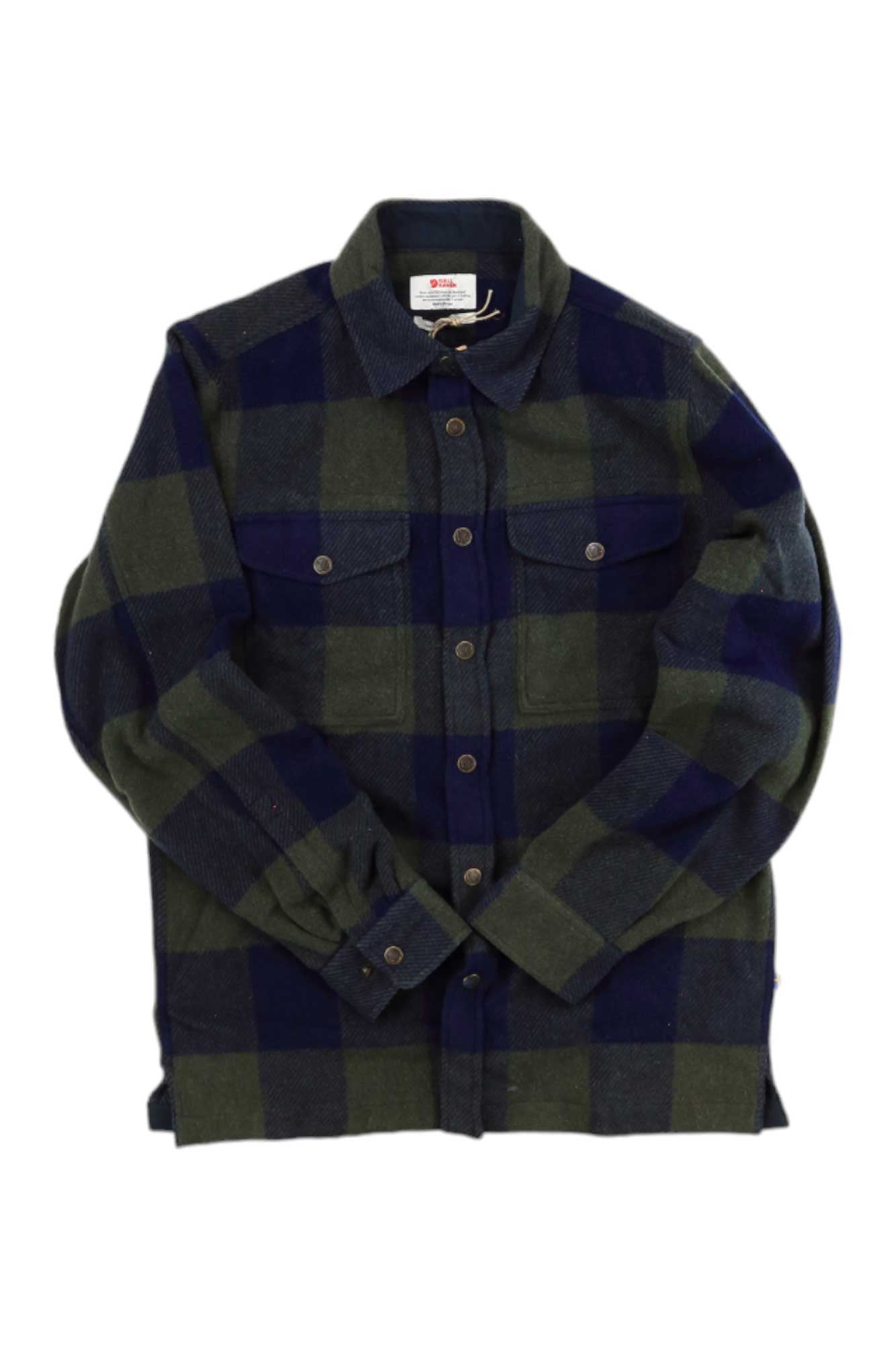 The Fjallraven Canada Shirt, a green and navy plaid button-up with long sleeves, two buttoned chest pockets, and a collar, is laid flat on white—an ideal heavy wool shirt for casual travel.