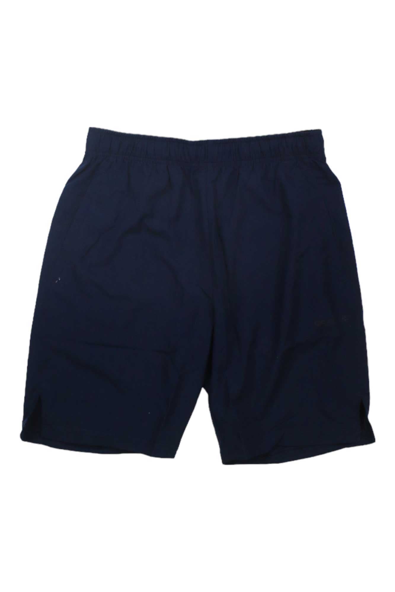 Craft Sportswear Men's Core Charge Short in navy blue features an adjustable, elastic waistband and small side slits. Laid flat on a white background. Moisture-wicking fabric keeps you cool and comfortable during workouts.