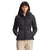 A woman with straight dark hair and bangs wears The North Face Womens Metropolis Jacket, a 550 fill goose down jacket with a hood, pairing it with light pants. She stands against a white background with her hands in the pockets.