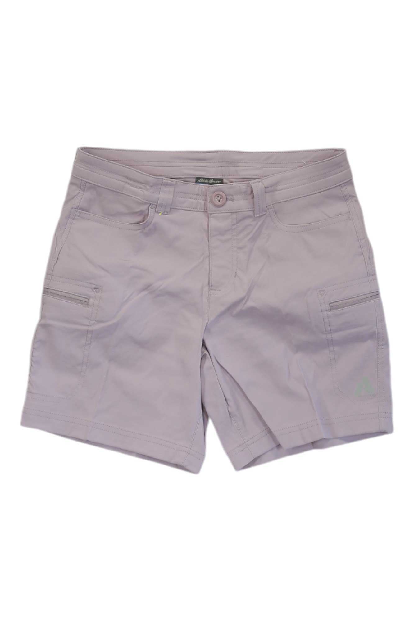 Eddie Bauer First Ascent Women's Guide Pro Short in light pink or lavender with UPF 50+, button and zipper closure, front pockets, and water-resistant side zippered pockets, laid flat on a white background.